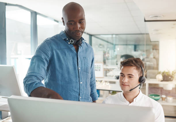 istock Man learning customer service training for telemarketing call center job, talking about crm and online support skills. Responding to contact us forms, questions and helping give customers good advice 1441343232