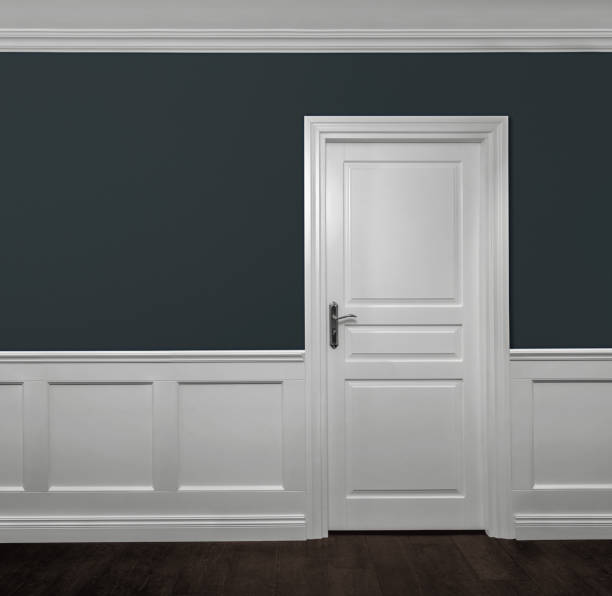 istock Elegant wooden door in empty room 1441343825