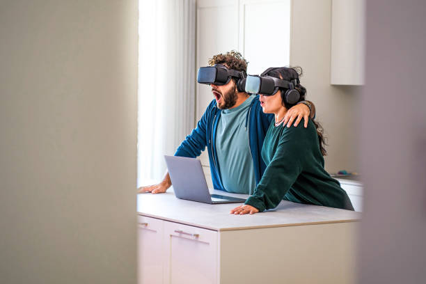 newlywed couple wondering about metaverse experience wearing 3d goggles having fun together stock photo