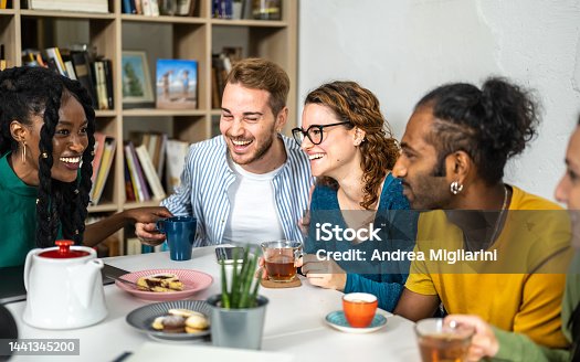 istock Group of happy friends having coffee break at bar cafeteria, young students people enjoying breakfast, friendship and good mood concept, focus on right woman drinking tea 1441345200