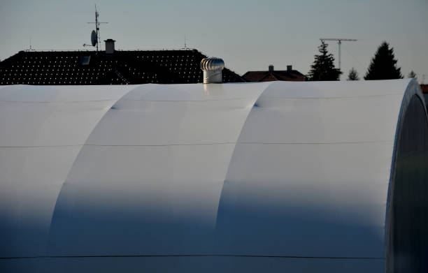 istock container building permanently forms a warehouse with offices. covered with a rubber sheet on tent structure. ventilation with help of a stainless steel propeller chimney. round, hangar, blue sky 1441345755