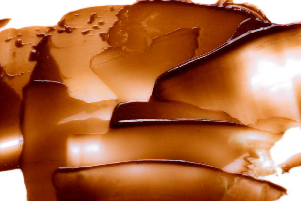 Brown chocolate caramel cosmetic product or hair dye sample swatch on white background close up.