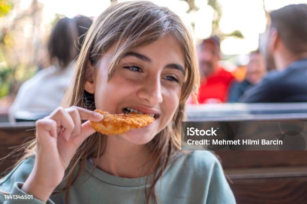 Beautiful Little Girl Enjoying Fried Chicken Stock Photo - Download Image Now - Biting, 12-13 Years, Beautiful People