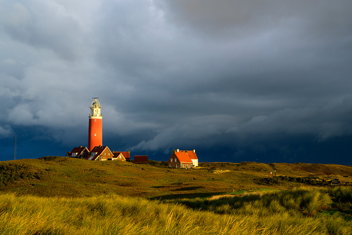 Lighthouse at the Wadden island Texel in the dunes during a stormy autumn morning. The Eierland lighthouse is located at the North point of the island.