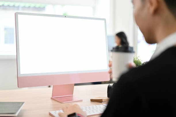 istock Young Asian male office worker working at his desk, looking at the computer screen 1441347002