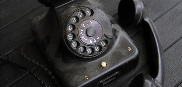 an old, dusty black rotary phone