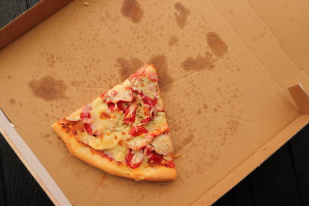 istock a pizza box with another slice of pizza 1441348372