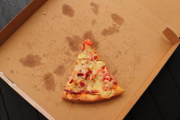 istock a pizza box with another slice of pizza 1441348414