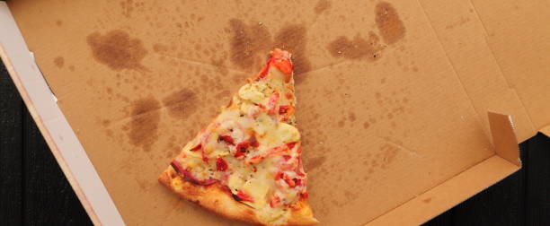 istock a pizza box with another slice of pizza 1441348426