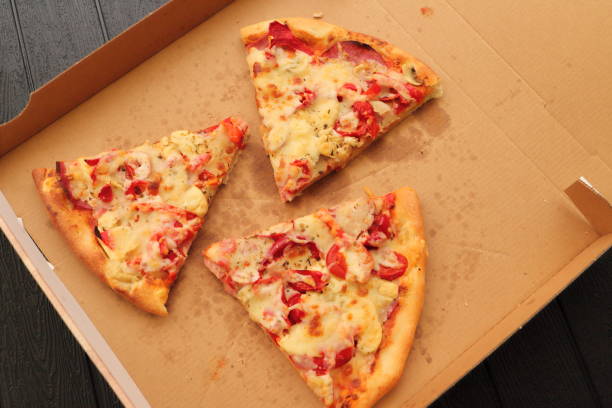 istock a pizza box with another slice of pizza 1441348486