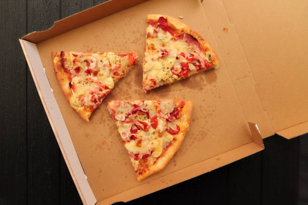 istock a pizza box with another slice of pizza 1441348504