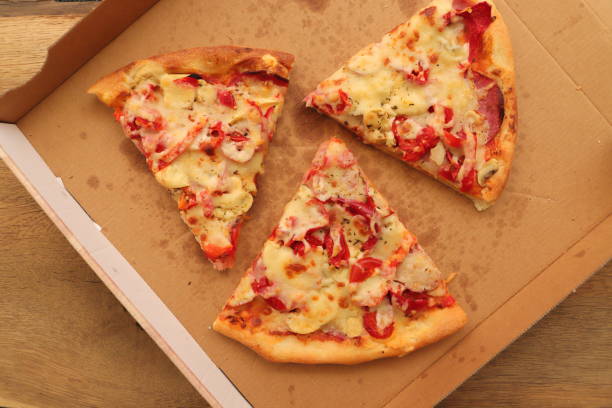 istock a pizza box with another slice of pizza 1441348658