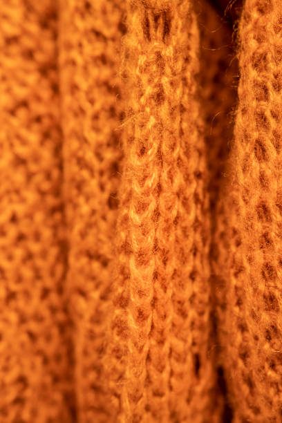 istock Close up on an orange wool sweater on a hanger. 1441350140