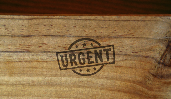 Urgent stamp printed on wooden box. Business time shedule and work plan concept.
