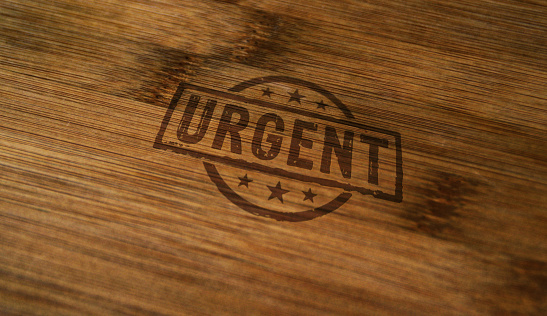Urgent stamp printed on wooden box. Business time shedule and work plan concept.