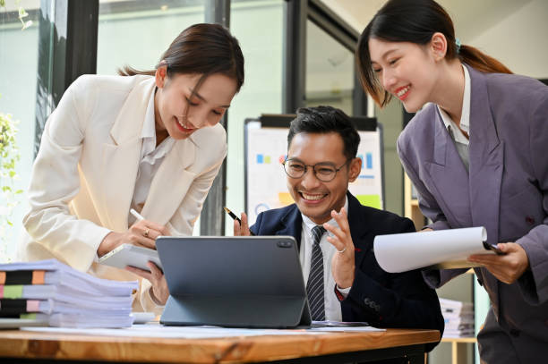istock Happy Asian businesspeople are working on a project together, talking, sharing ideas 1441351129