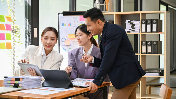 istock Professional male boss training his employees on analyzing financial data in the office. 1441351130