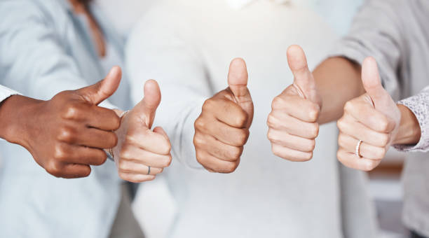 thumbs up, diversity and a yes sign by business people in a startup company or successful marketing agency. hands, collaboration and team of workers that approve of a global partnership and support - congratulating winning agreement thumbs up imagens e fotografias de stock