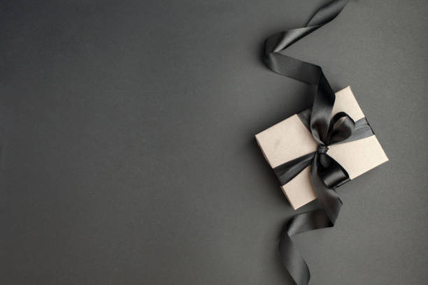 istock Craft gift box on a dark background, decorated with a textured bow, creating a romantic luxury atmosphere. For birthday, anniversary presents, gift post cards, banner, flyer, invitation, voucher 1441352833