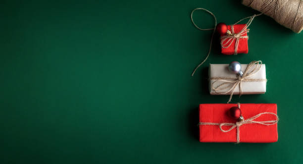 istock Christmas tree made of gift boxes on green background. Top view, flat lay, copy space. 1441353087