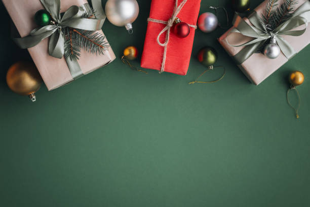 istock New Year banner with Christmas gift boxes and decorations on khaki background. 1441353119