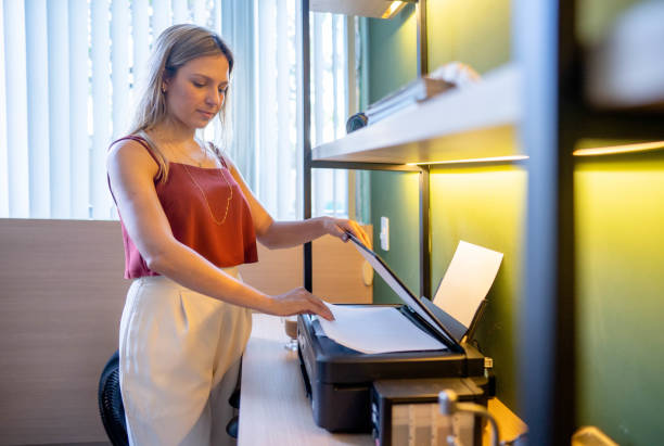istock Woman at her office printing some papers 1441353848