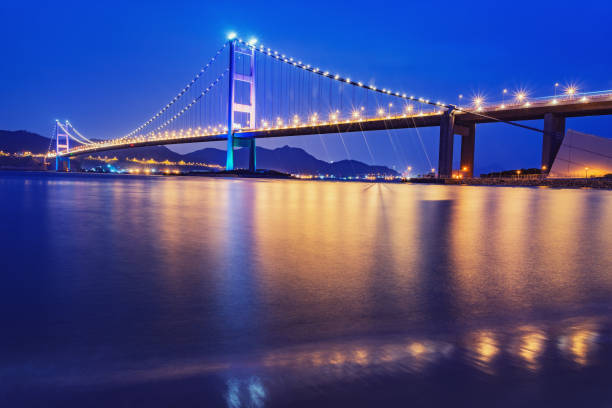 istock Suspension bridge to Park island at evening time. 1441354495