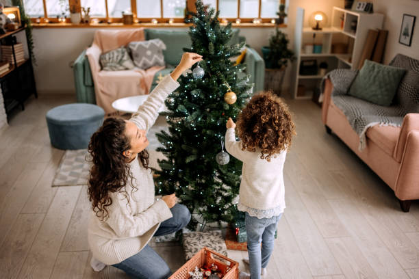 Decorating Christmas tree with your mum stock photo