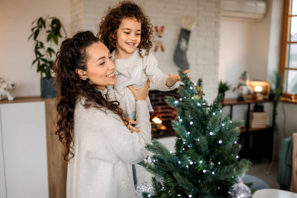 istock Decorate Christmas tree with your daughter 1441354911
