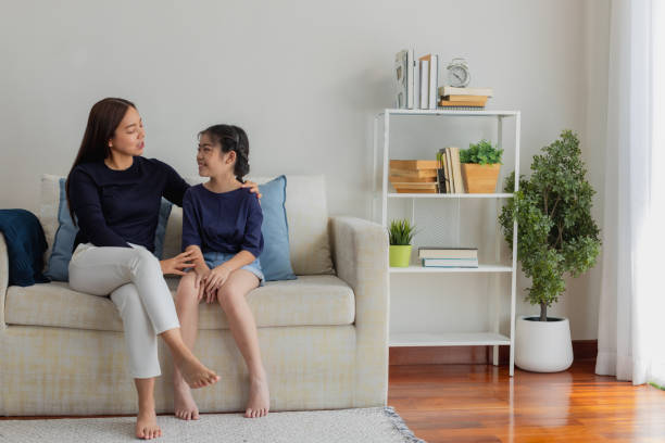 Teenage talking to her mother in living room. Teens, Tweem Asia, lifestyle. asian mother talking to child stock pictures, royalty-free photos & images