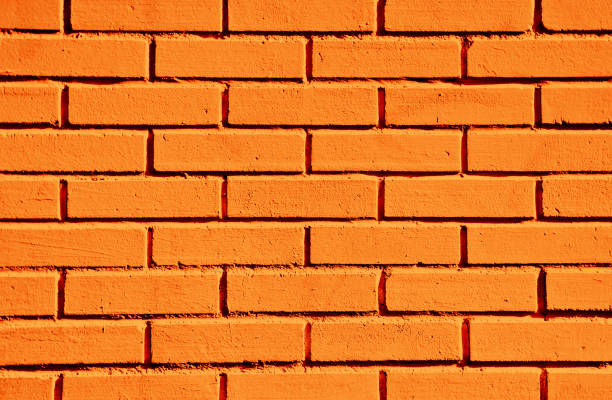 istock Orange paint brick wall. Abstract color home facade background. Decorative artistic urban construction. Grunge color street design texture. 1441362875
