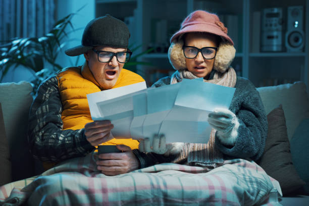 istock Sad couple checking expensive utility bills 1441363240