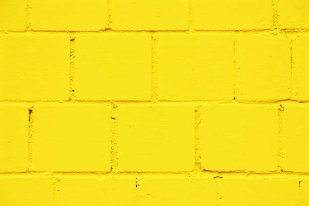 istock Yellow paint brick wall. Abstract color home facade background. Decorative artistic urban construction. Grunge color street design texture. 1441363241