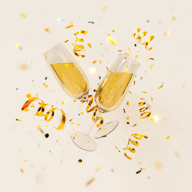 istock Glowing champagne glasses in golden confetti 1441363645