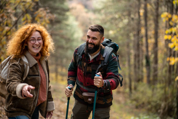 istock Happy young couple enjoying their hike through a forest 1441364218
