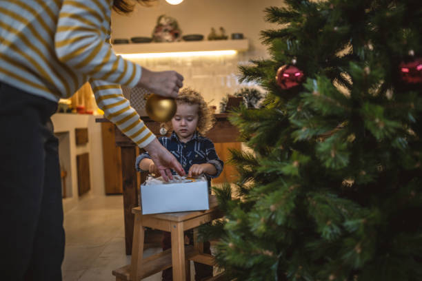 istock Mother and son decorating Christmas tree 1441364775