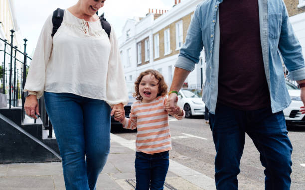 istock Parents and son holding hands while walking in the city 1441365114