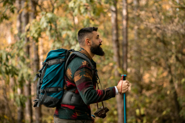 istock Young man with a beard hiking in the woods 1441365439