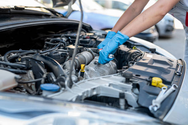 istock experienced female mechanic is servicing a car in her workshop. 1441365514