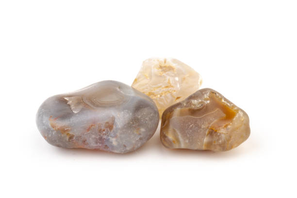 istock Multicolored gemstones, tumbled minerals. Bostwan agate of various sizes on a white background. 1441366502