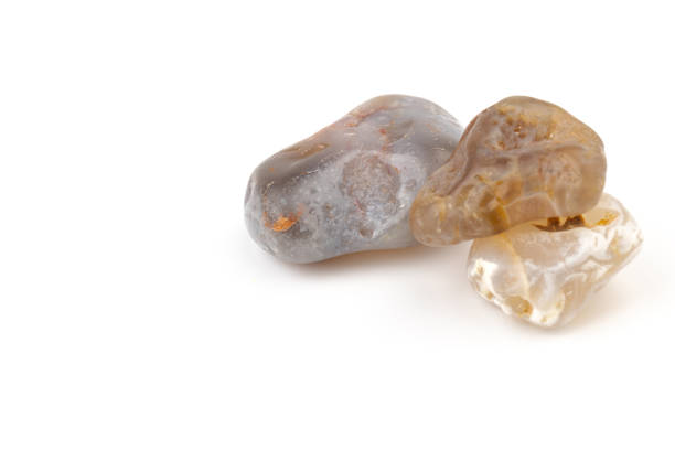 istock Multicolored gemstones, tumbled minerals. Bostwan agate of various sizes on a white background. 1441366549