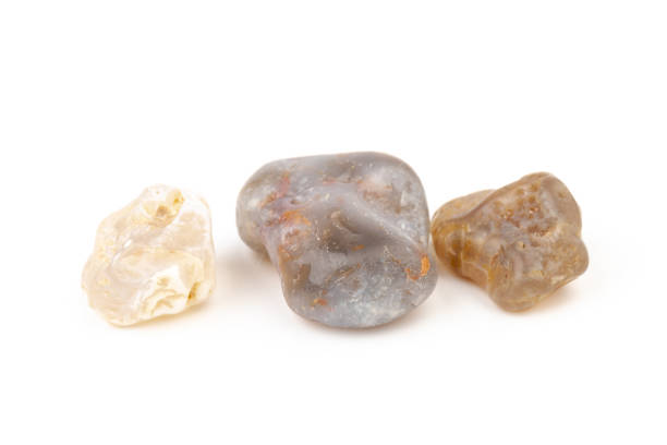 istock Multicolored gemstones, tumbled minerals. Bostwan agate of various sizes on a white background. 1441366562