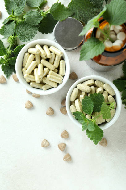 istock Nettle pills and ingredients on white textured table 1441367522