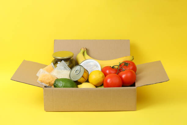 istock Concept of donate with donation box on yellow background 1441367824