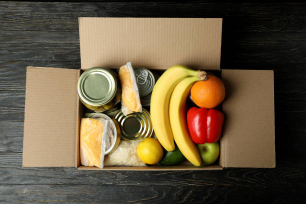 istock Concept of donate with donation box on wooden table 1441367979