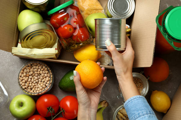 istock Donation concept with female hands and different food 1441368818