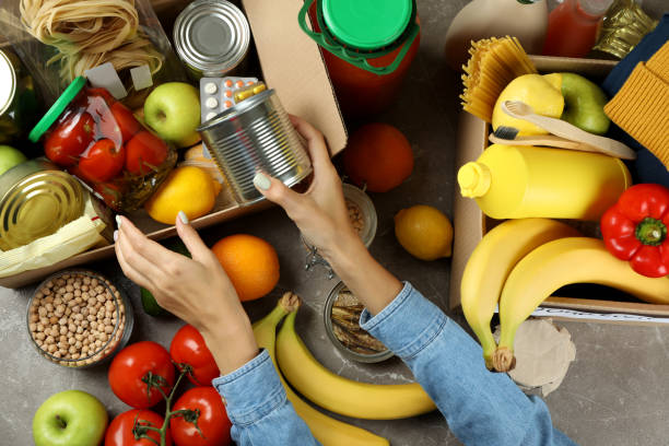 istock Donation concept with female hands and different food 1441368874