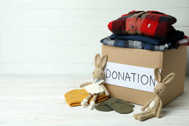 istock Concept of donate with donation box on white wooden table 1441369315