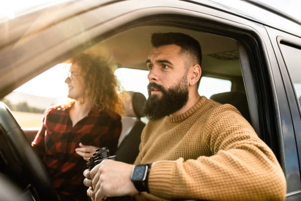 istock Young couple driving in a car 1441369382