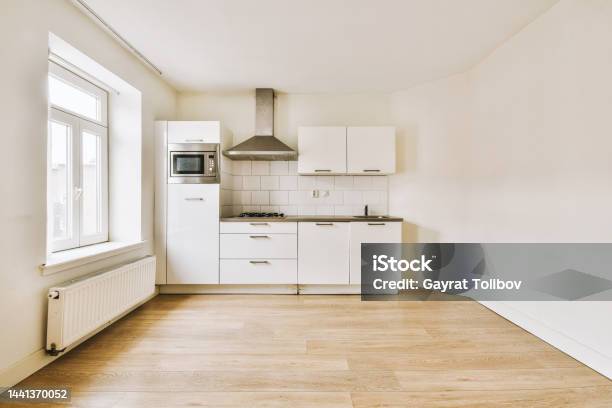 View Of A Spacious Bright Room With A Small Open Kitchen Stock Photo - Download Image Now